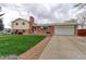 Charming two-story home features a well-maintained lawn and a classic brick exterior at 10538 Quivas St, Northglenn, CO 80234