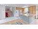 Bright kitchen features a central island, and stairs leading to the upper levels at 10538 Quivas St, Northglenn, CO 80234