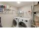 Functional laundry room with wire shelving and modern, front-loading washer and dryer at 10538 Quivas St, Northglenn, CO 80234