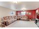 Spacious living room with a plush sectional sofa and carpeted flooring at 10538 Quivas St, Northglenn, CO 80234