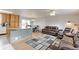 Open-concept living space features hardwood floors, a large island, and a cozy seating area at 10538 Quivas St, Northglenn, CO 80234