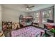 bedroom with bunk beds, a ceiling fan, and a window with sheer pink curtains at 16051 E Alaska Pl # 4, Aurora, CO 80017