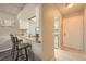 View of the kitchen with counter seating and wood countertops. The kitchen features white cabinetry and a stainless steel sink at 16051 E Alaska Pl # 4, Aurora, CO 80017