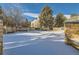 Snowy common area featuring stone benches and mature evergreens, offering a serene outdoor space at 16051 E Alaska Pl # 4, Aurora, CO 80017