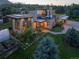 Beautiful modern home with lush front lawn, stone details, a garden, and solar panels on the roof at 5123 Quaker St, Golden, CO 80403