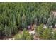 Aerial view of a red roofed house nestled in a vast forest, close-up and detailed at 17422 N Canyon Rd, Littleton, CO 80127