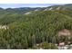 Scenic aerial view of a home nestled in a lush forest, showcasing the beauty of nature at 17422 N Canyon Rd, Littleton, CO 80127