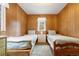 Bright bedroom features wood paneled walls, two beds, and plush carpeting at 17422 N Canyon Rd, Littleton, CO 80127