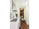 Galley kitchen boasts stainless sink, white cabinets, and a view to the next room at 17422 N Canyon Rd, Littleton, CO 80127