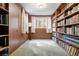 Home library with hardwood floors, and built-in bookshelves providing an ideal space for reading and storage at 17422 N Canyon Rd, Littleton, CO 80127