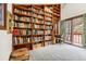 Room featuring wall to wall bookcase, natural light, and a sliding door to the balcony at 17422 N Canyon Rd, Littleton, CO 80127