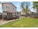 Expansive backyard with a deck, seating area, and lush lawn, ideal for outdoor activities and entertaining at 331 Chelsea St, Castle Rock, CO 80104