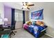 Cozy bedroom with a ceiling fan, large window, and colorful decor at 331 Chelsea St, Castle Rock, CO 80104