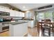 Bright and modern kitchen featuring island and an adjacent dining area at 331 Chelsea St, Castle Rock, CO 80104
