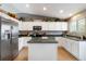 Bright kitchen with white cabinets, stainless steel appliances, and functional island at 331 Chelsea St, Castle Rock, CO 80104