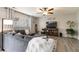 Cozy living room with large window, a ceiling fan, wood-style flooring, and decorative touches at 331 Chelsea St, Castle Rock, CO 80104