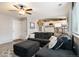 Bright living room with a large sectional sofa, open stairs, and a ceiling fan at 331 Chelsea St, Castle Rock, CO 80104