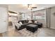 Inviting living room featuring a gray sectional sofa, ceiling fan and stairs leading to the kitchen at 331 Chelsea St, Castle Rock, CO 80104
