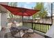 A patio with an umbrella-covered table and chairs overlooking a fenced yard at 331 Chelsea St, Castle Rock, CO 80104