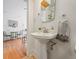 Charming bathroom with a classic pedestal sink and a modern black and white hand towel at 945 N Washington St # 201, Denver, CO 80203