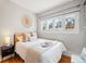 Comfortable bedroom with a decorative wall piece, hardwood floors, and natural light at 945 N Washington St # 201, Denver, CO 80203