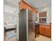 Modern kitchen equipped with stainless steel fridge and gas range, and a glimpse into the adjacent bedroom at 945 N Washington St # 201, Denver, CO 80203