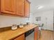 Kitchen counter with granite countertops, wood cabinets, and view of a dining table and chairs at 945 N Washington St # 201, Denver, CO 80203