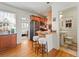 Compact kitchen featuring stainless steel appliances, a breakfast bar with stools, and hardwood floors at 945 N Washington St # 201, Denver, CO 80203