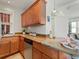 Efficient kitchen design with wood cabinets, granite countertops, and a stainless steel dishwasher at 945 N Washington St # 201, Denver, CO 80203