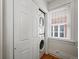 Convenient laundry area features a stacked washer and dryer, maximizing space by the bright window at 945 N Washington St # 201, Denver, CO 80203