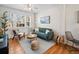 This bright living room features a comfortable sofa, ample natural light, and classic hardwood floors at 945 N Washington St # 201, Denver, CO 80203