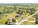Aerial view of a home with a long driveway on a large grassy lot surrounded by mature trees at 9232 N Surrey Dr, Castle Rock, CO 80108