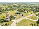Wide aerial shot of the property on a large grassy lot surrounded by mature trees in a neighborhood at 9232 N Surrey Dr, Castle Rock, CO 80108