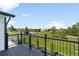 Balcony view showing manicured landscaping and neighborhood homes under a clear sky at 9232 N Surrey Dr, Castle Rock, CO 80108