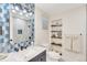 Charming bathroom with blue accents, patterned mirror detail, and decorative shelving at 9232 N Surrey Dr, Castle Rock, CO 80108
