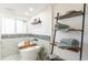 Serene bathroom with freestanding tub, decorative shelves, and soft lighting at 9232 N Surrey Dr, Castle Rock, CO 80108