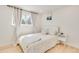 Bright bedroom with a comfortable bed, modern nightstand, and a window view at 9232 N Surrey Dr, Castle Rock, CO 80108