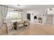Bright dining room showcasing natural light, stylish decor, and wood-look flooring at 9232 N Surrey Dr, Castle Rock, CO 80108