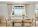 Dining area with a modern chandelier, neutral decor, and a large window with a view at 9232 N Surrey Dr, Castle Rock, CO 80108