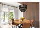 Contemporary dining area with a round wood table, designer lighting and paneled accent wall at 9232 N Surrey Dr, Castle Rock, CO 80108