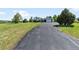 View of the long driveway leading up to the home with a two car garage and a green lawn at 9232 N Surrey Dr, Castle Rock, CO 80108