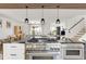 Modern kitchen with stainless steel appliances, island cooktop, and adjacent dining and living spaces at 9232 N Surrey Dr, Castle Rock, CO 80108
