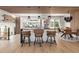 Modern kitchen with island and bar seating, stainless steel appliances, and adjacent dining area at 9232 N Surrey Dr, Castle Rock, CO 80108