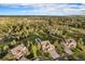 Aerial view of the property showcasing the expansive lot, mature trees, and surrounding neighborhood at 7624 Russell Ct, Arvada, CO 80007