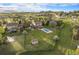 Expansive aerial view of the property showcasing a large backyard, swimming pool, and surrounding neighborhood at 7624 Russell Ct, Arvada, CO 80007