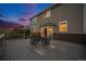 Backyard deck featuring an outdoor dining area and sunset views at 7624 Russell Ct, Arvada, CO 80007