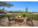 Inviting backyard featuring a stone fire pit, comfortable seating, and well-manicured lawn perfect for entertaining at 7624 Russell Ct, Arvada, CO 80007
