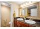 Bathroom with double sinks, granite countertops, and decorative mirror at 7624 Russell Ct, Arvada, CO 80007