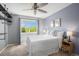 Serene bedroom featuring soft blue walls, a comfortable bed, and a bright window view at 7624 Russell Ct, Arvada, CO 80007