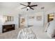 Bedroom features plush neutral carpet, ceiling fan, and decorative shelving at 7624 Russell Ct, Arvada, CO 80007